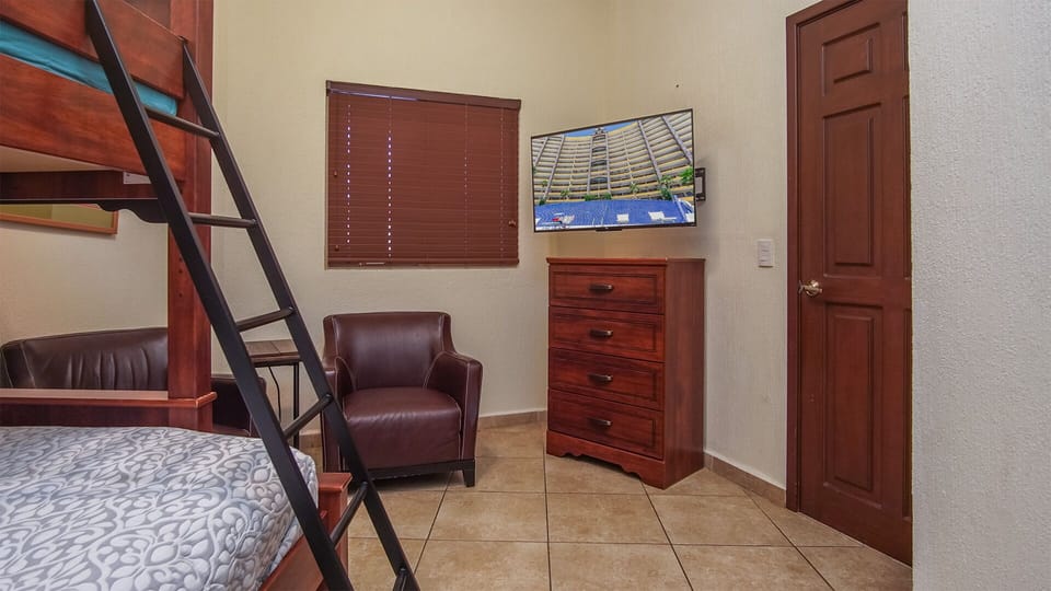 The TV and dresser in the fourth bedroom.
