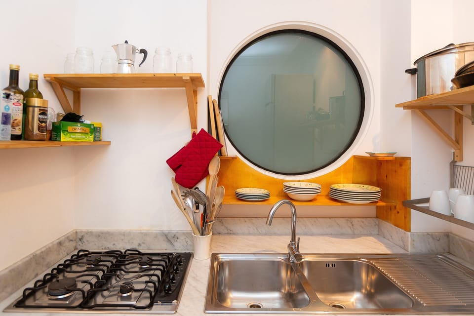 Fully equipped kitchen with cooking utensils and cutlery.
