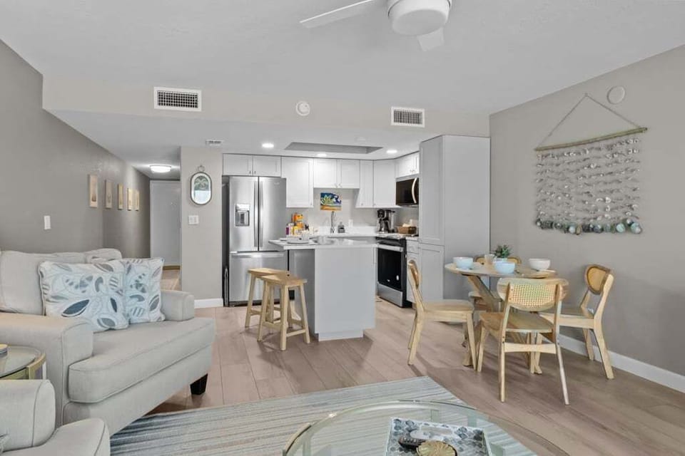 Cozy and modern open space featuring a fully equipped kitchen, inviting dining area, and bright living room—perfect for relaxing and enjoying your stay.