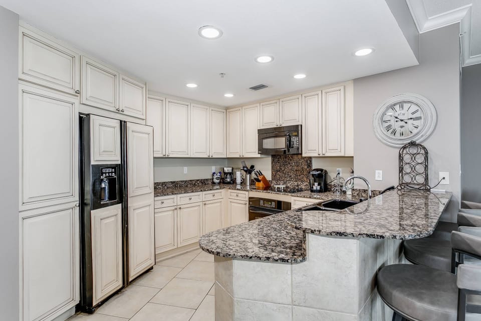 Updated kitchen with tile floors and granite countertops