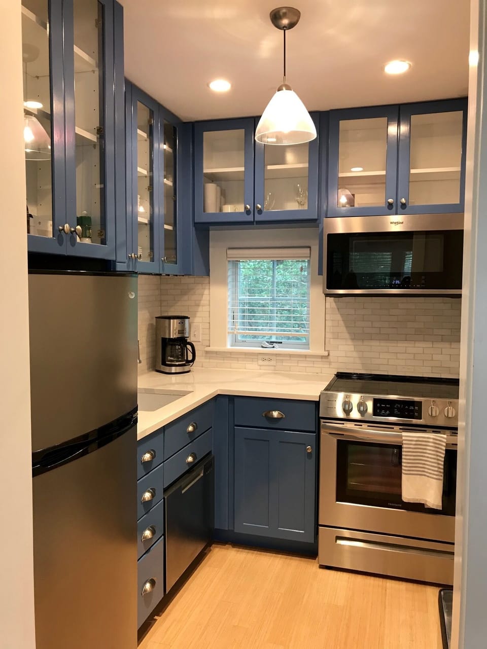 Newly remodeled kitchen off of main living area with quartz countertops, stove.