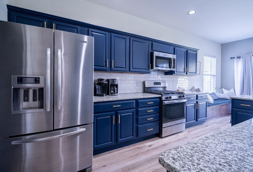 Fully stocked modern kitchen with stainless steel appliances and ample prep space.