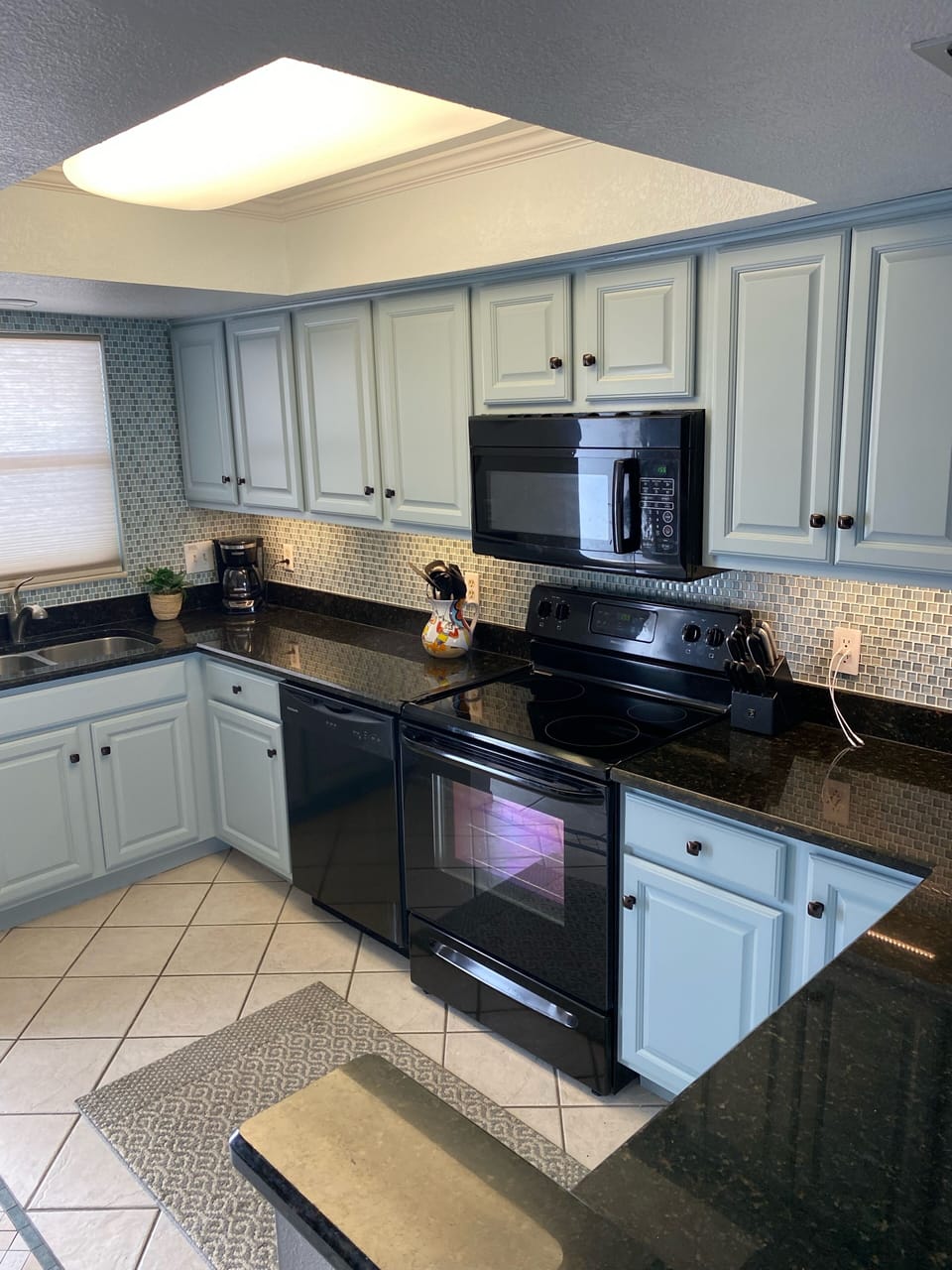 Freshly updated cabinets stocked with dishes, utensils, pots and pans. 