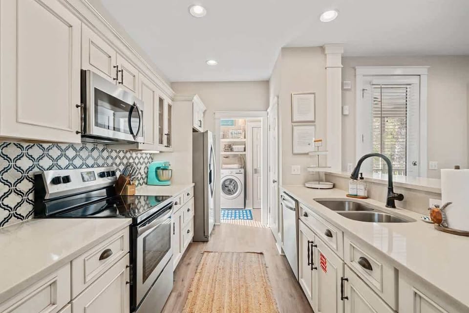 - Fully equipped kitchen with stainless steel appliances and stylish tile backsplash - Thoughtfully designed open plan layout with easy access to laundry and pantry - Quartz countertops and stylish cabinetry make meal preparation a breeze