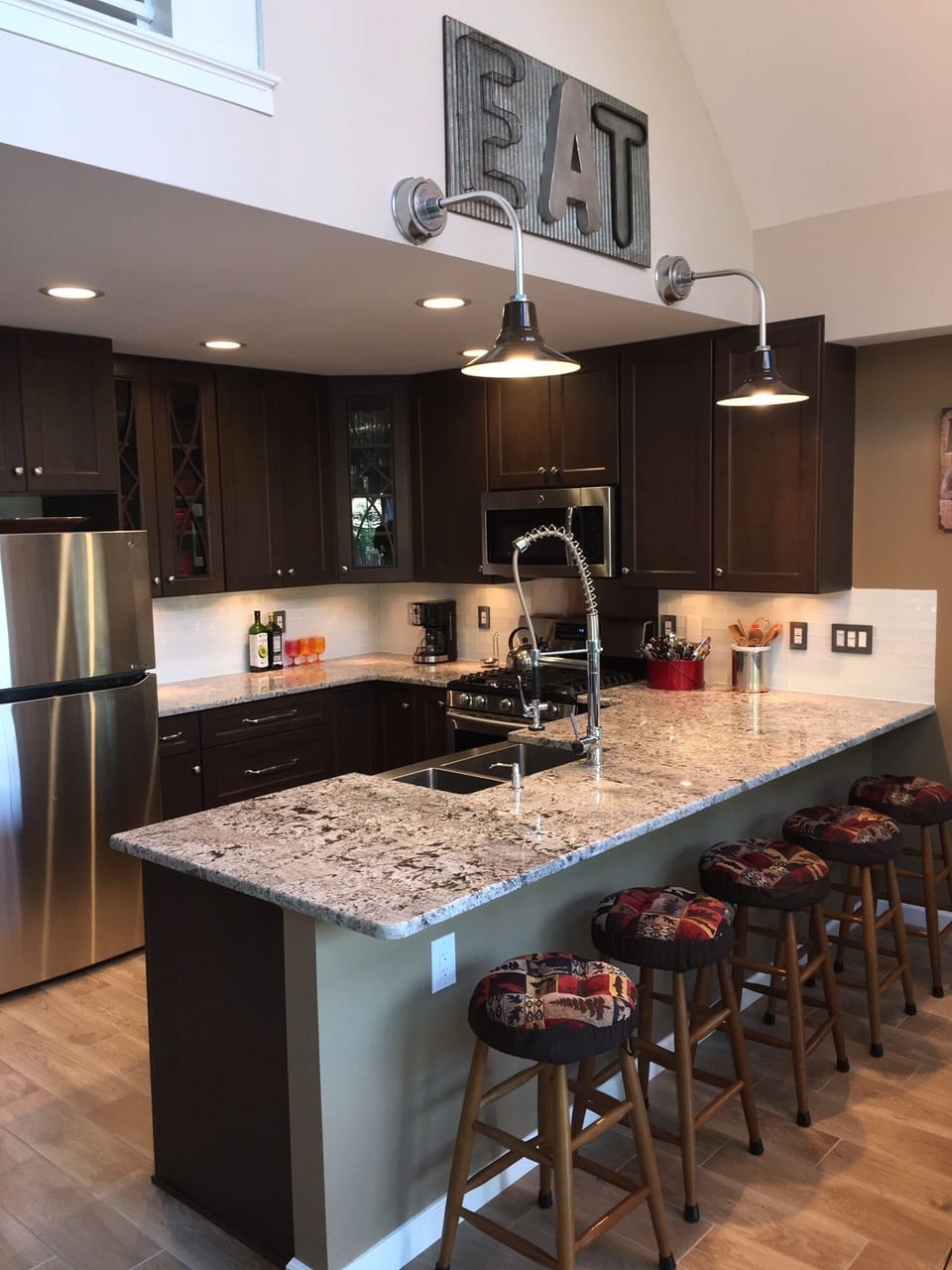 Chef's kitchen with granite countertops and stainless steel appliances.