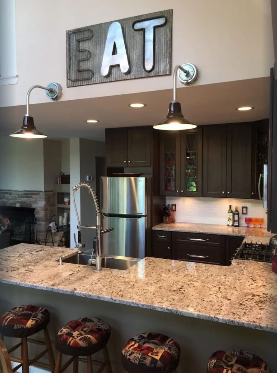 Chef's kitchen with granite countertops and stainless steel appliances.