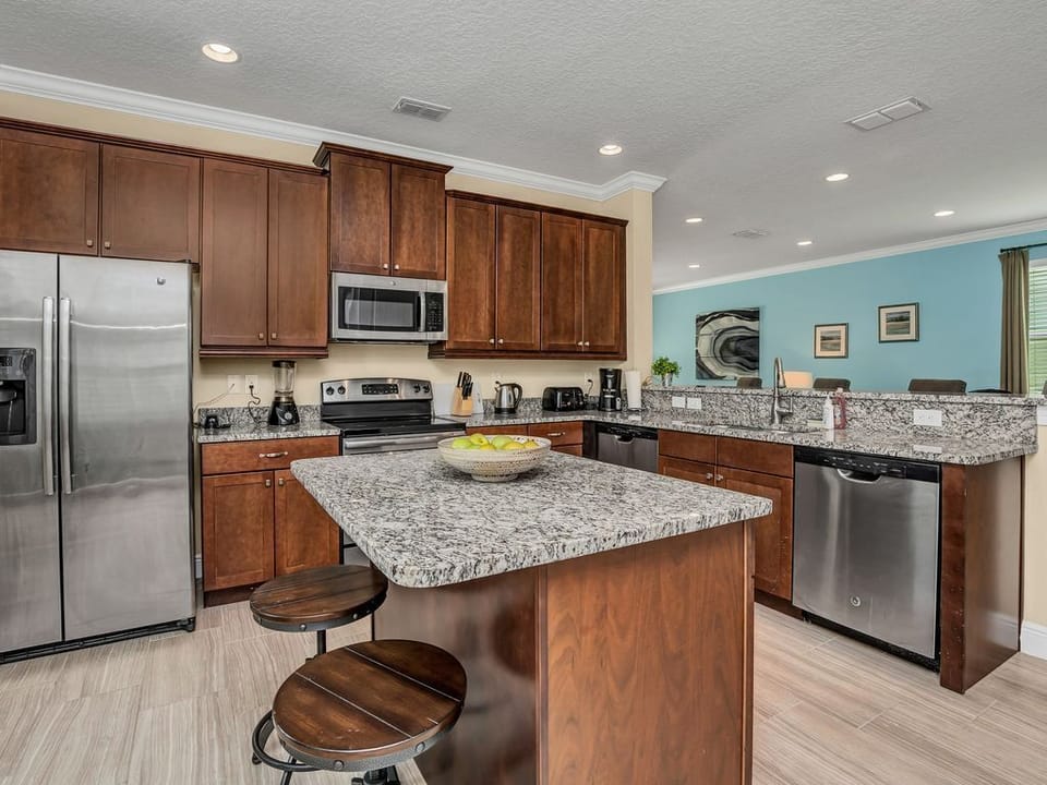 Stunning granite countertops and stainless steel appliances for family meals and cooking in luxury.