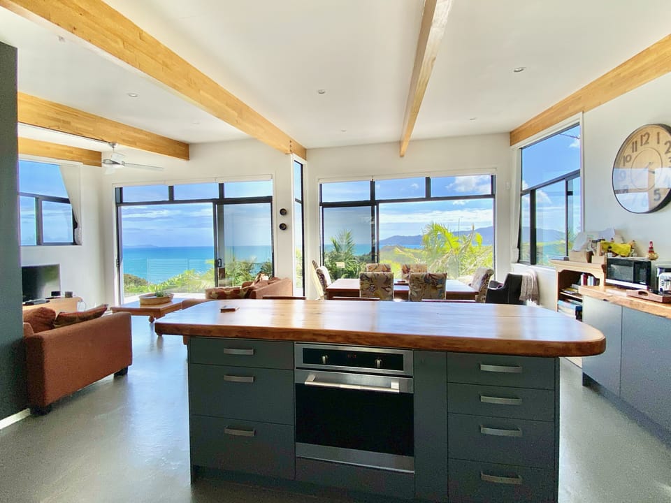 Kitchen island overlooks dining area with views across the bay.