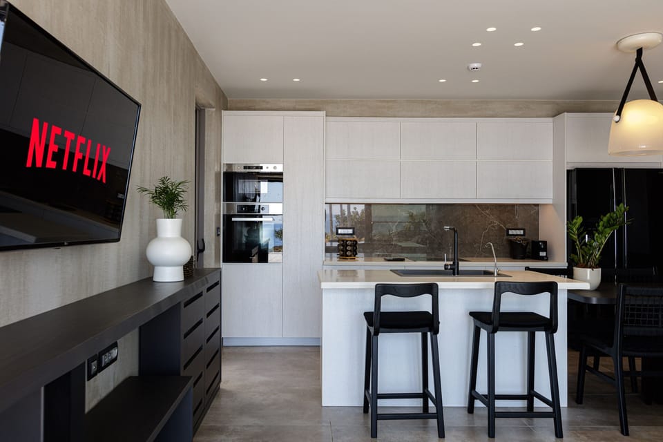 The kitchen features an island counter and two stools!