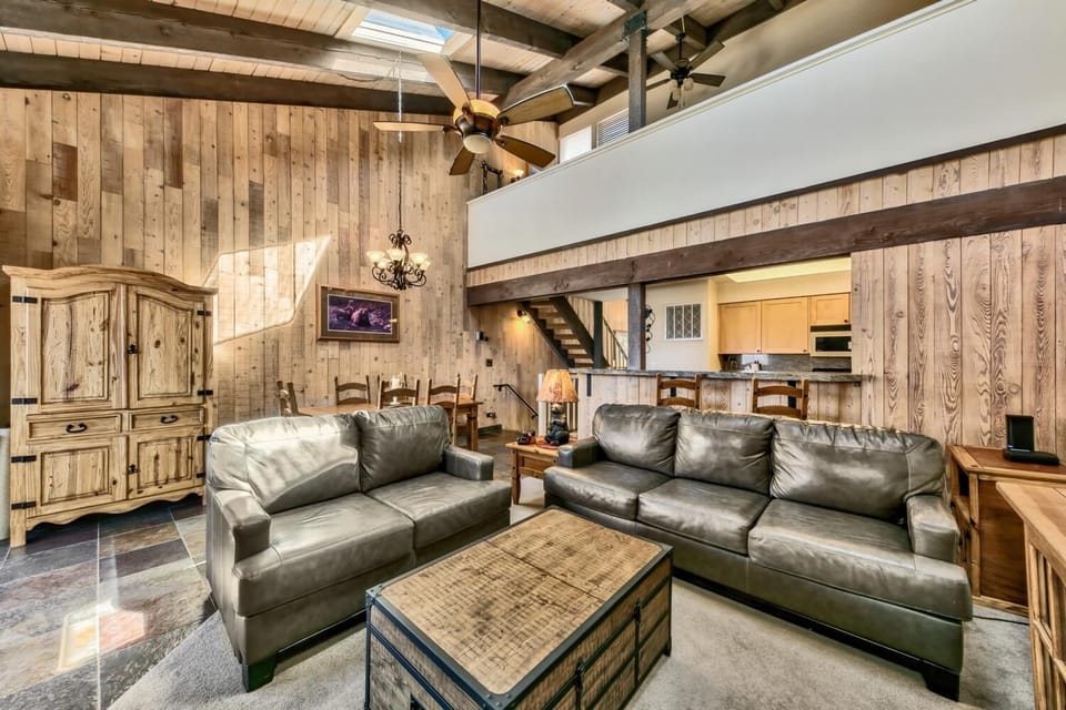 Sink into plush leather sofas beneath soaring beamed ceilings. Your rustic retreat combines cozy comfort with stunning architectural details.