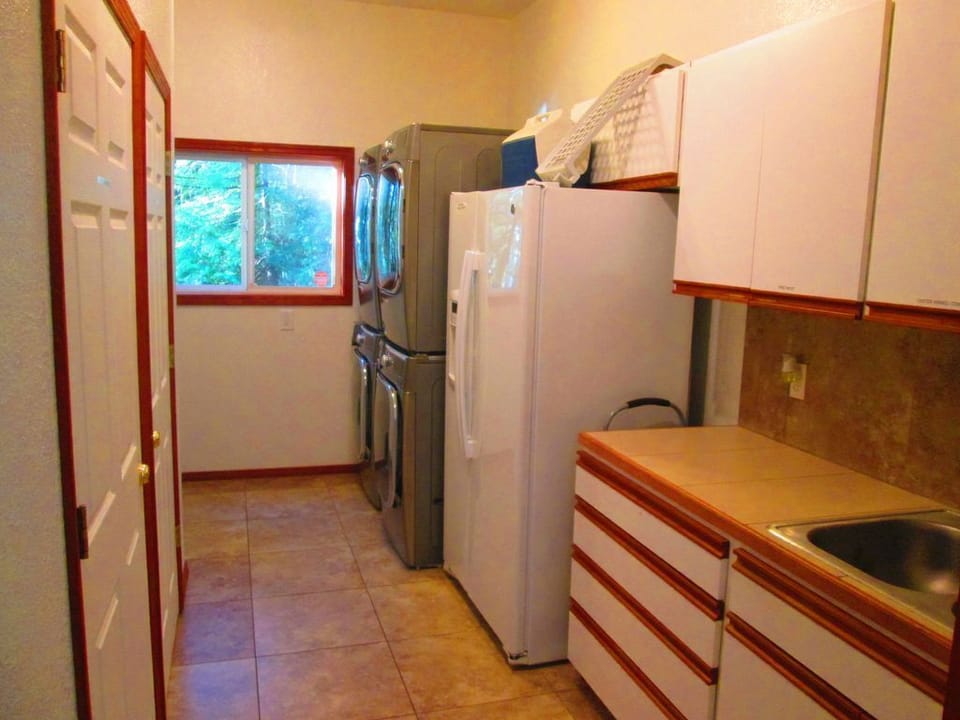 Laundry room 2 washers, 2 dryers,
sink and fridge with bait 4 seasonal crabbing.