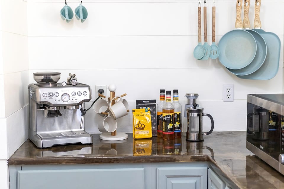 - Fully stocked coffee and tea bar featuring premium brews, syrups, and tools - Enjoy barista style mornings with a top tier espresso machine and French press - Thoughtfully arranged setup adds charm and convenience to your stay