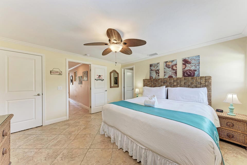 Drift into peaceful dreams in this coastal-inspired bedroom with tropical ceiling fan and charming nautical artwork creating your perfect seaside retreat.