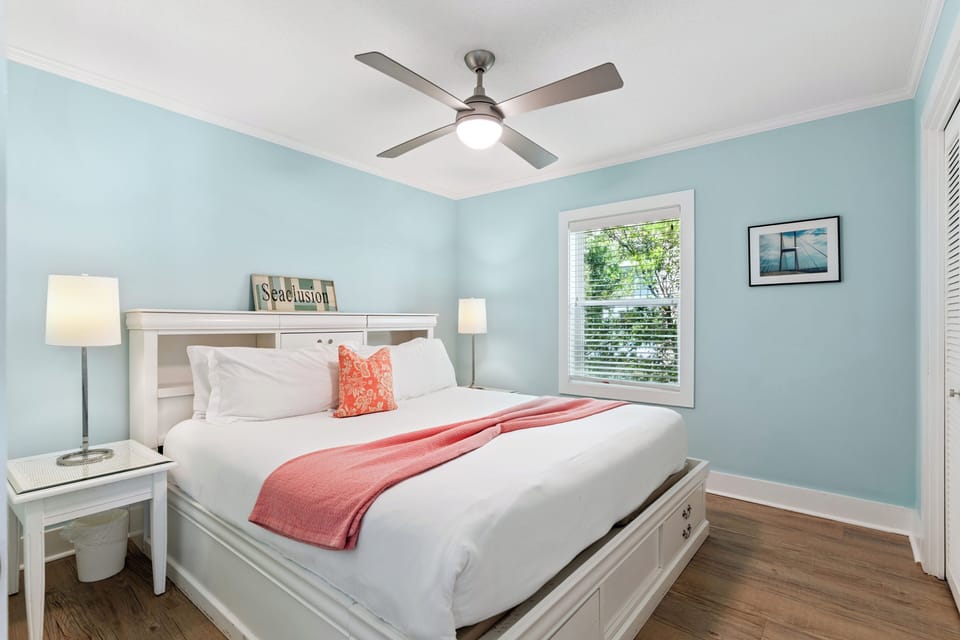 Drift off to sleep in this serene coastal bedroom with soft blue walls and crisp white linens.