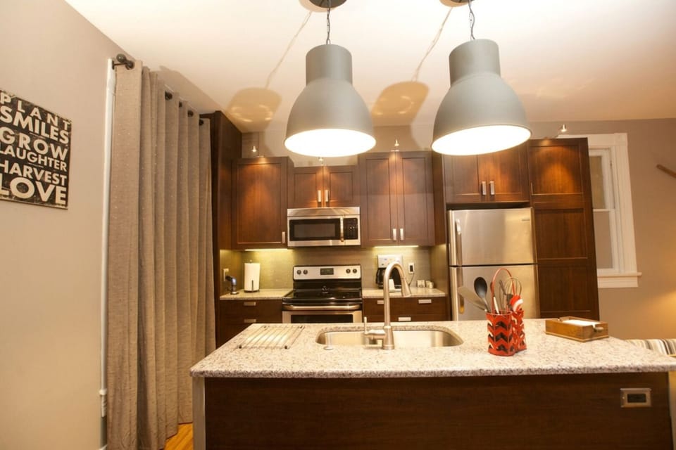Plenty of room to prepare meals and snacks on kitchen island and countertops - blackout shades cover the historic double hung windows in Vetehuset - Skorda