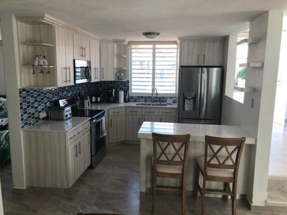 Fully stocked kitchen with counter seating for 2.