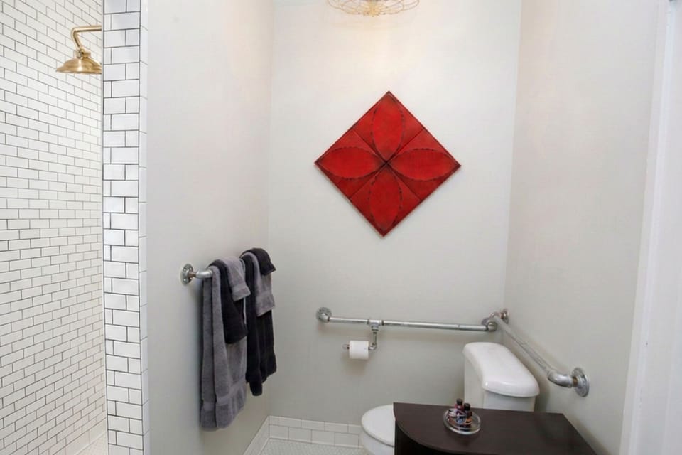 Handy-dandy grab rails around the commode for your convenience