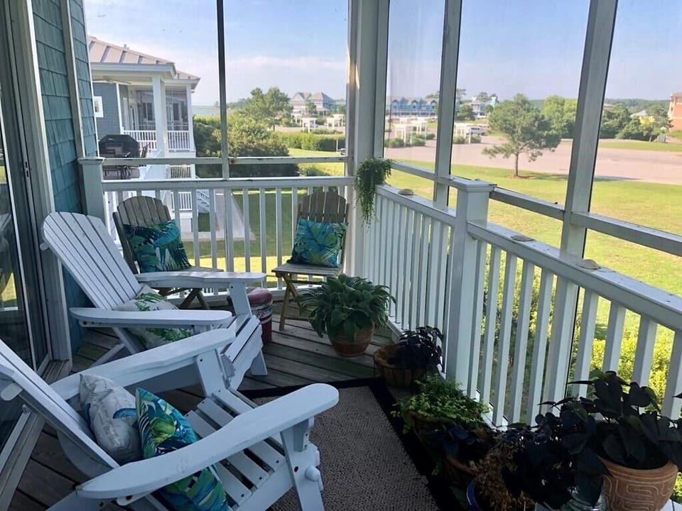Screened porch is perfect to enjoy after a day at the beach and overlooks marina