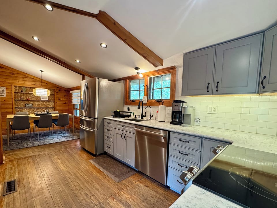 Modern cabin kitchen with stainless appliances & cozy dining room