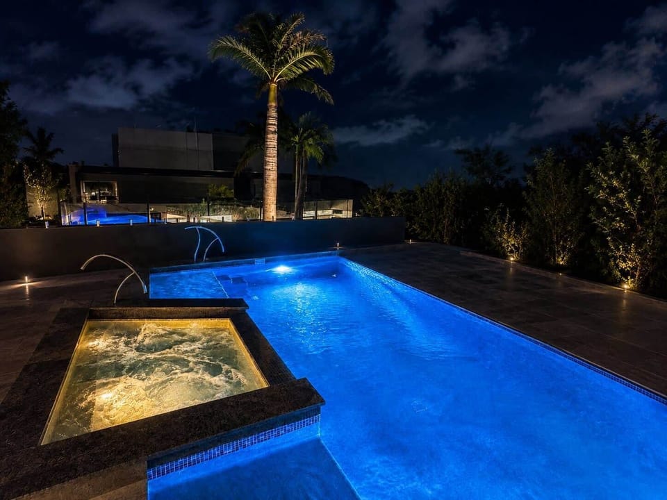 Heated Communal pool and spa at night. Open 7am - 9pm