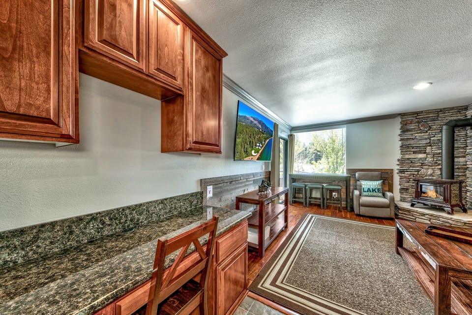 Cozy up in your mountain retreat with warm wood cabinetry, granite counters, and a crackling stone fireplace—perfect for relaxing after alpine adventures.