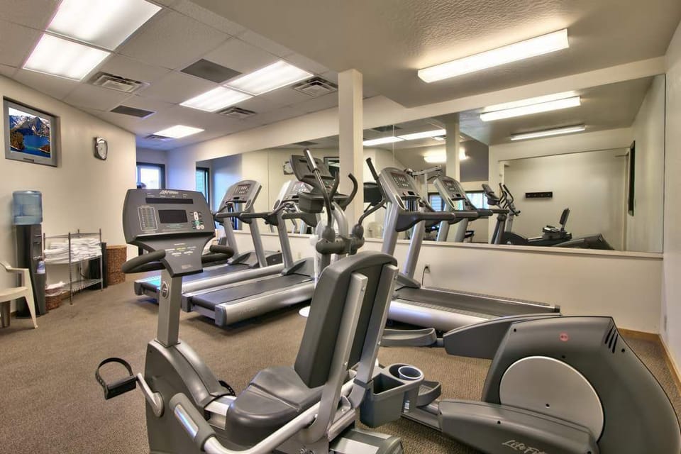 Lakeland Village lodge fitness center featuring cardio machines, treadmills, and free weights to help you maintain your workout routine.