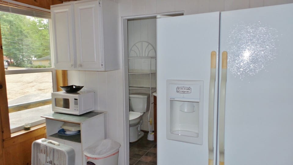 VIEW OF BATHROOM OFF THE KITCHEN,