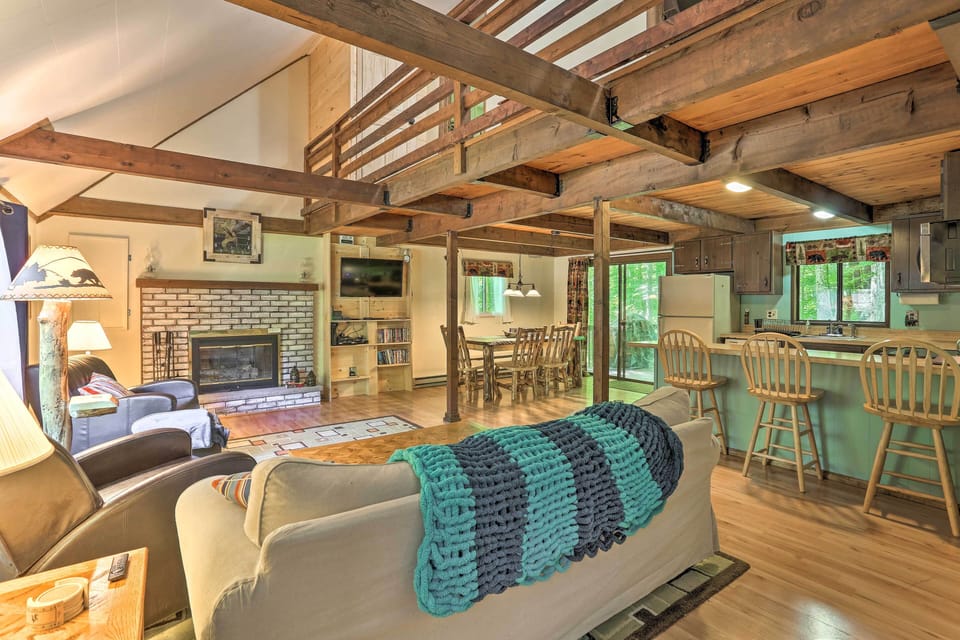 The living room has vaulted ceilings with exposed beams and rustic touches.