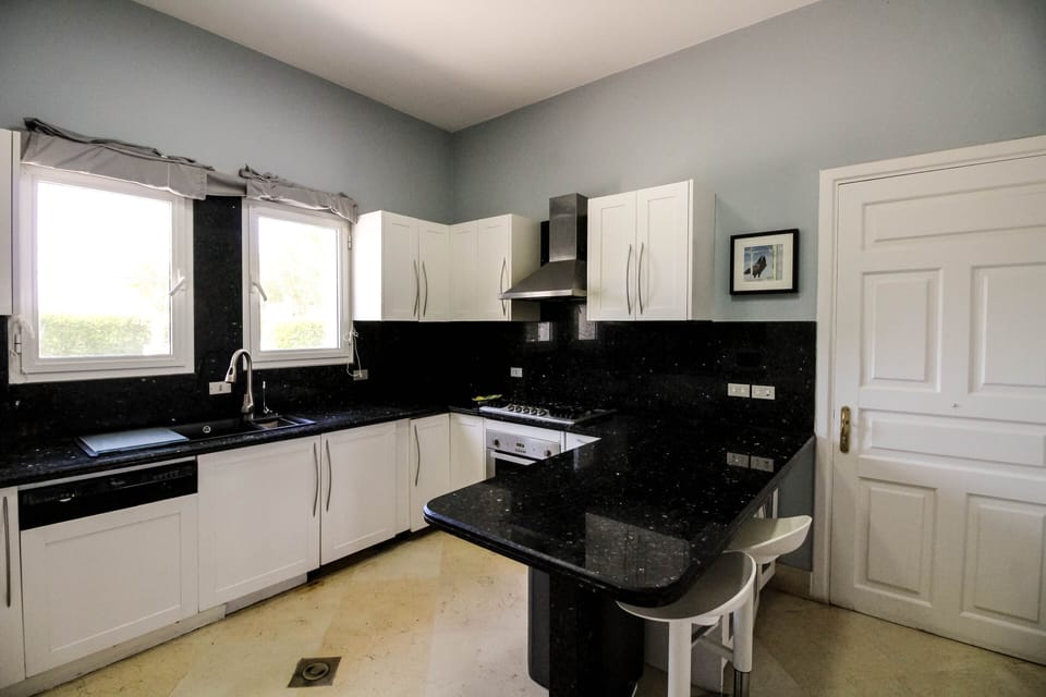 Modern kitchen with dishwasher, washing machine and dryer.  