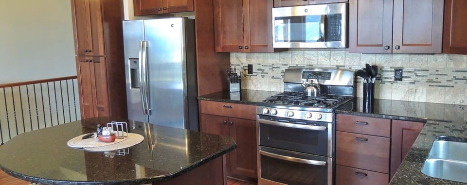 Cooks kitchen with stainless appliances and lots of work space