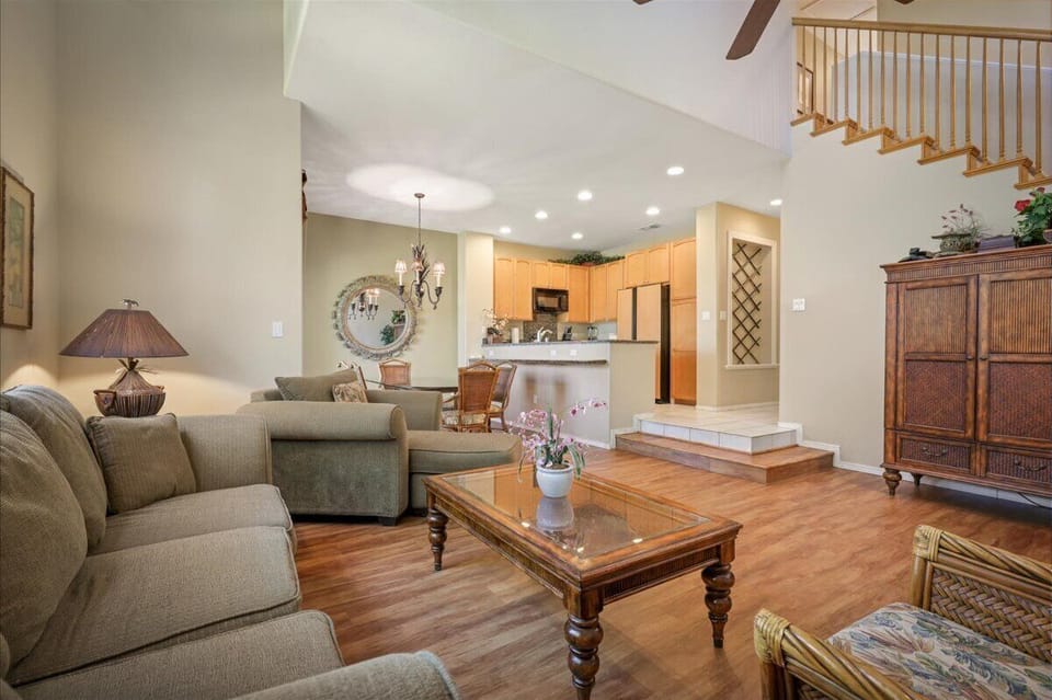 Settle into this spacious, light-filled living area where vaulted ceilings and warm hardwood floors create an inviting retreat. Your open-concept space flows seamlessly into the well-equipped kitchen, perfect for relaxing evenings.