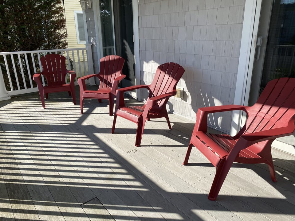First floor front porch with Adirondack chairs 