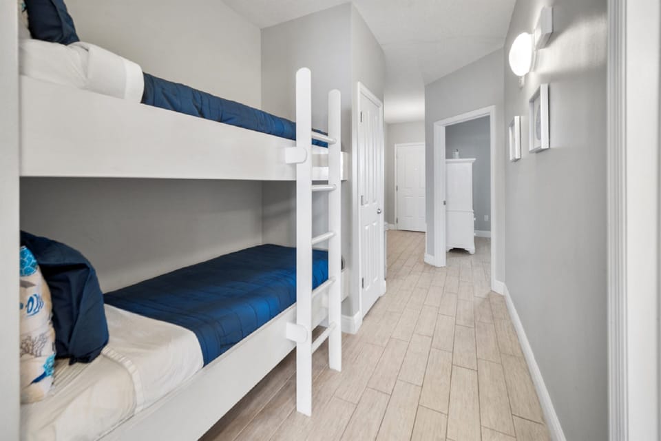 Your kids will love this bright bunk room with crisp blue bedding and modern touches.