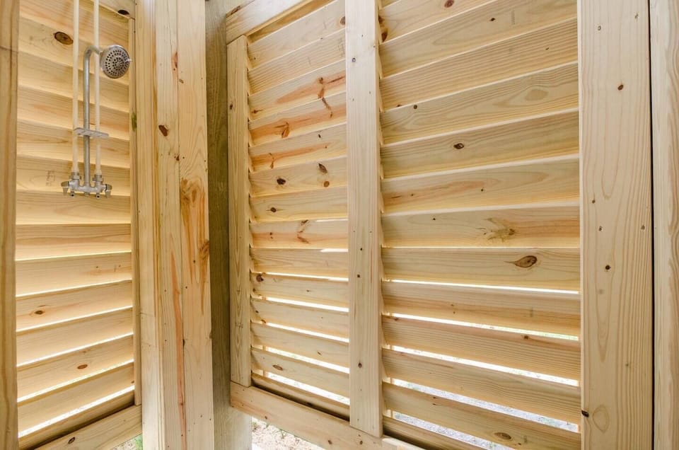 Outdoor shower with hot and cold water—wash off sandy feet before heading inside after beach time.