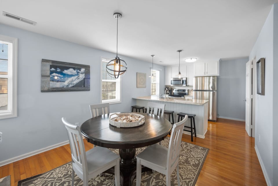 Dining area with 4 chairs and 4 additional bar seats in kitchen.