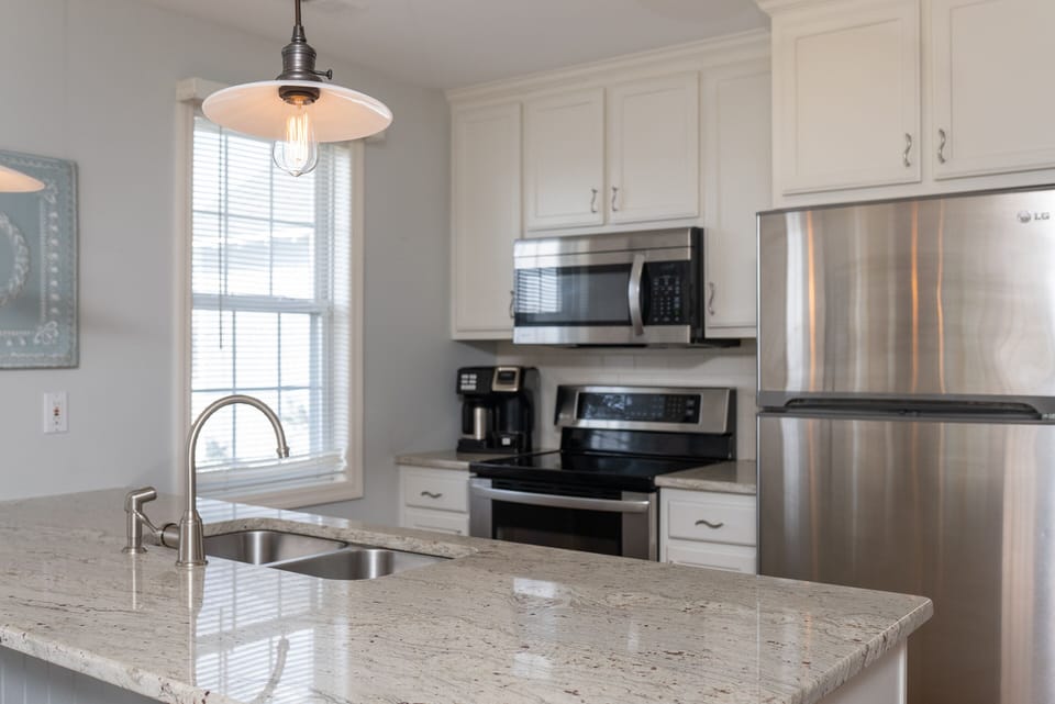 Full size kitchen w/ Fridge, oven, stovetop and microwave. Coffee dual brew.