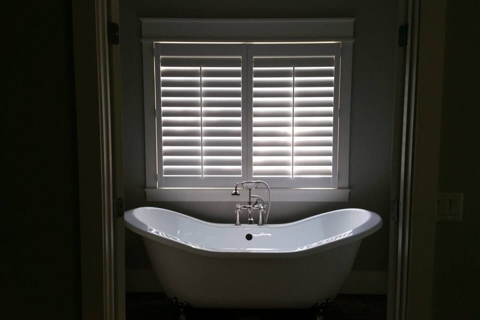 Clawfoot tub and shower in upstairs bathroom of cottage rental