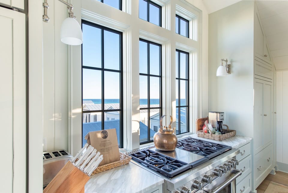 Chef's Kitchen with Natural Lighting, Luxury Marble Island, and Vaulted Shiplap Ceilings