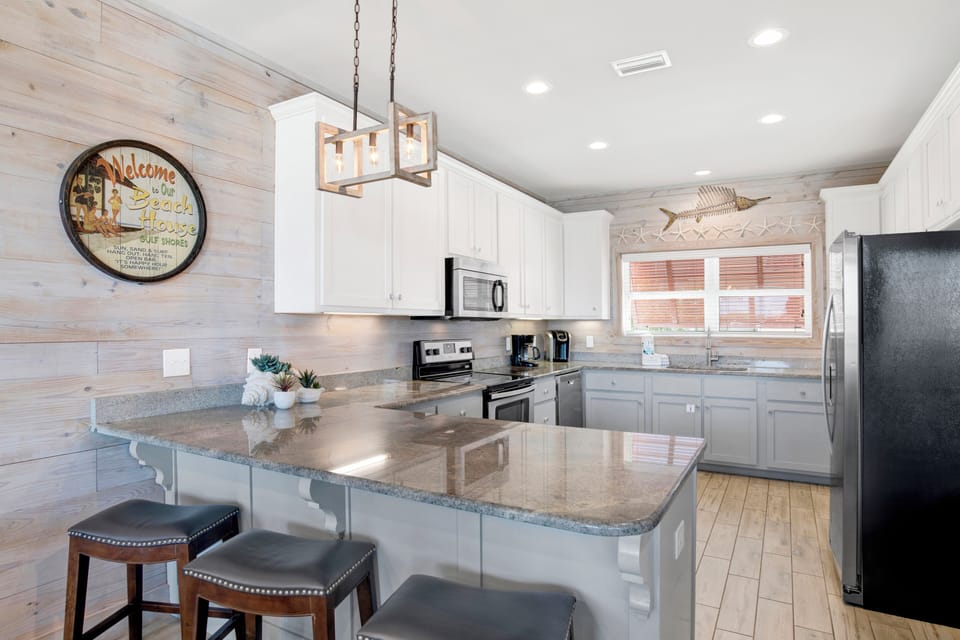 Fully equipped kitchen with stone counters and stainless steel appliances