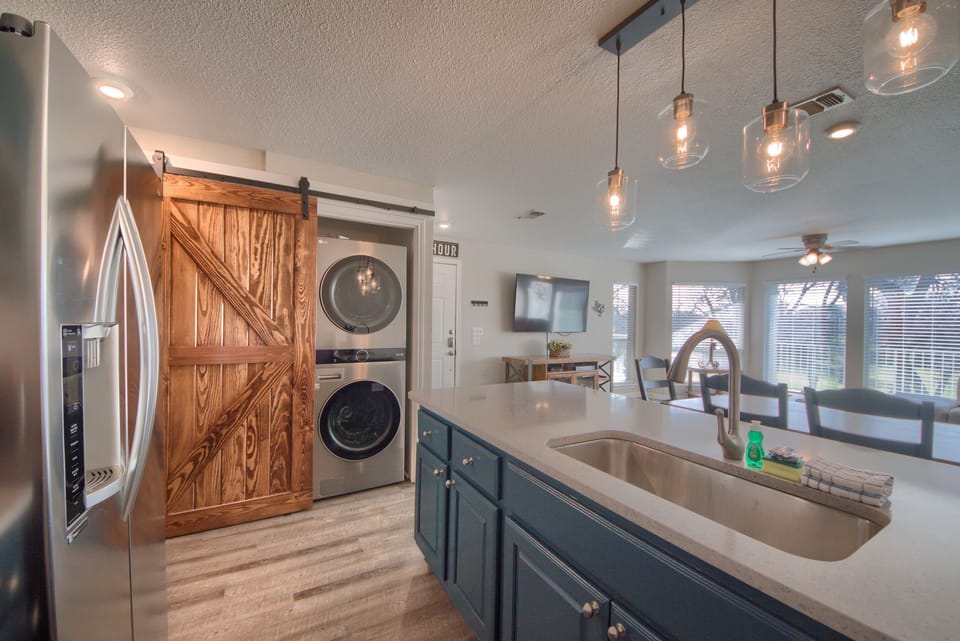 Stacked Washer and Dryer behind a Beautiful Barn Door!