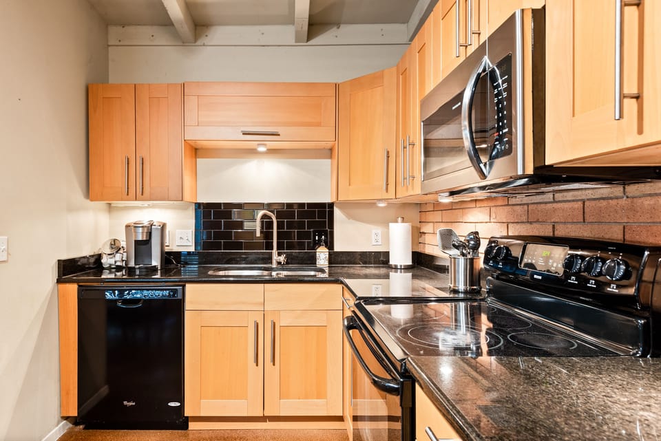 Spacious kitchen with dishwasher, stove, and microwave
