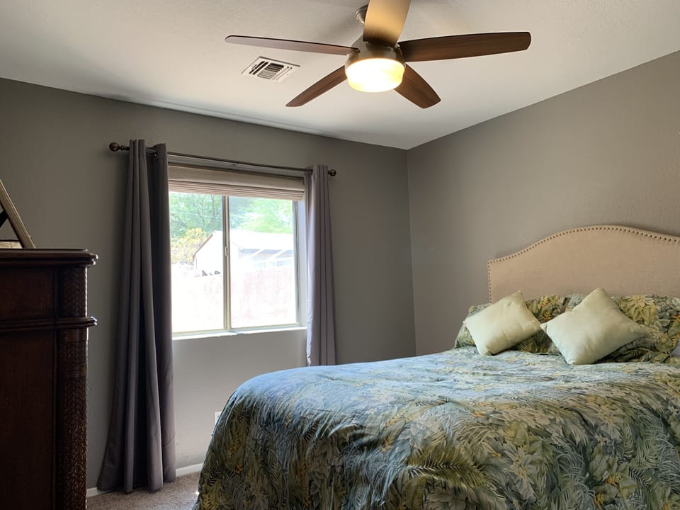 Guest room with queen bed and dresser