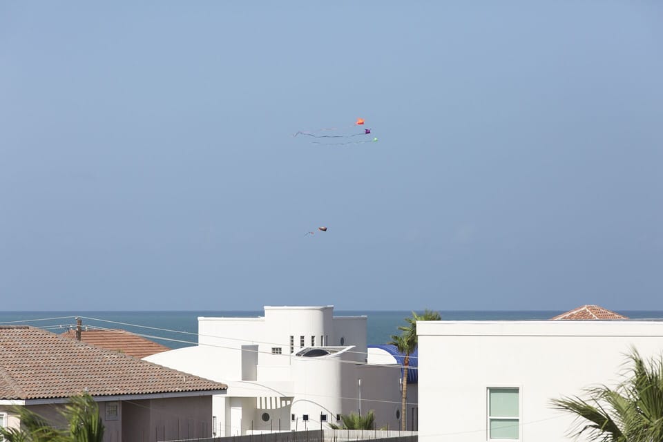 Rooftop deck with coastal breezes and views stretching toward the Gulf