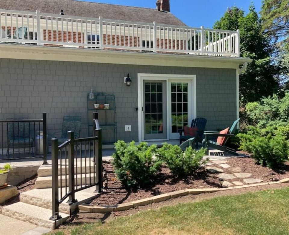 Private patio entrance overlooks the back garden and communal living areas.