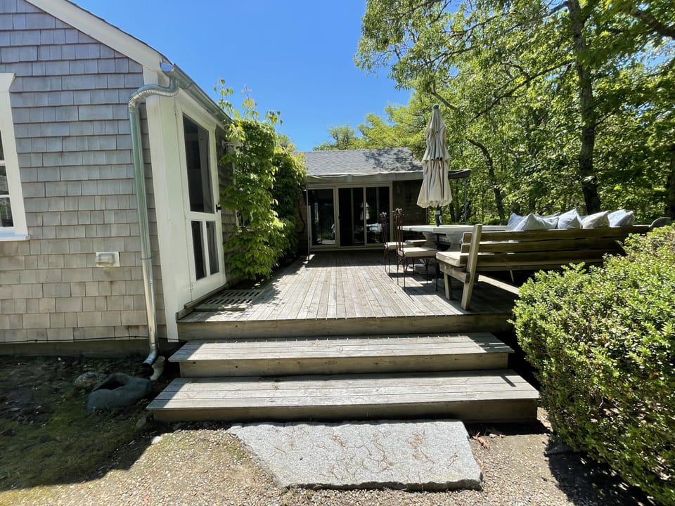 entrance and deck at the lower house with outdoor seating & dining