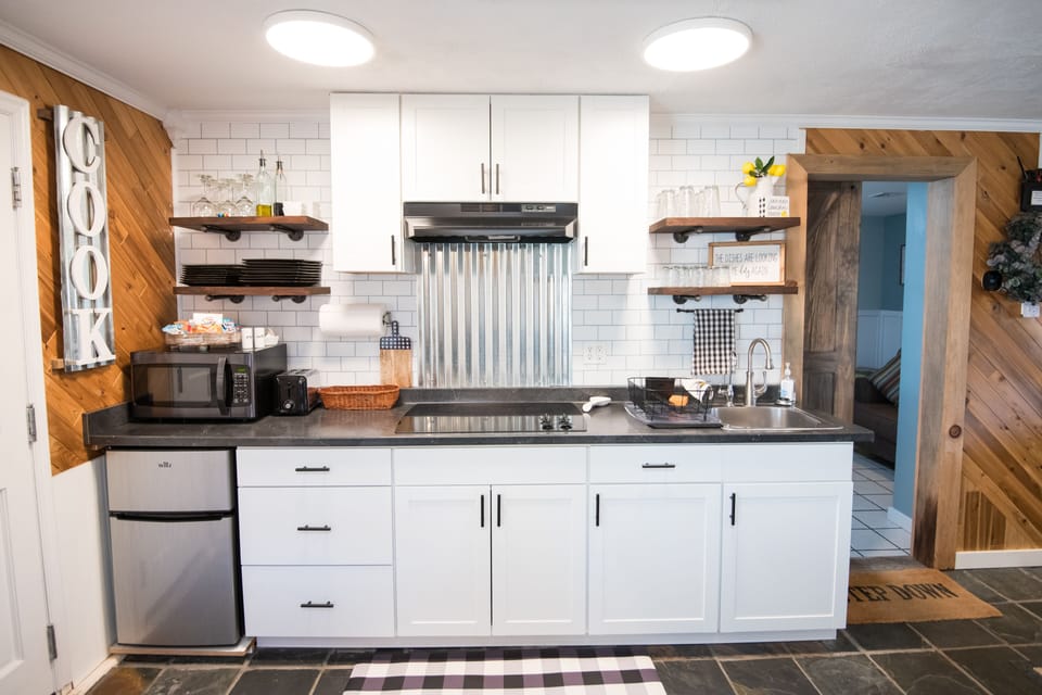 Kitchenette has  smooth top stove and a microwave. Full size fridge in mudroom 