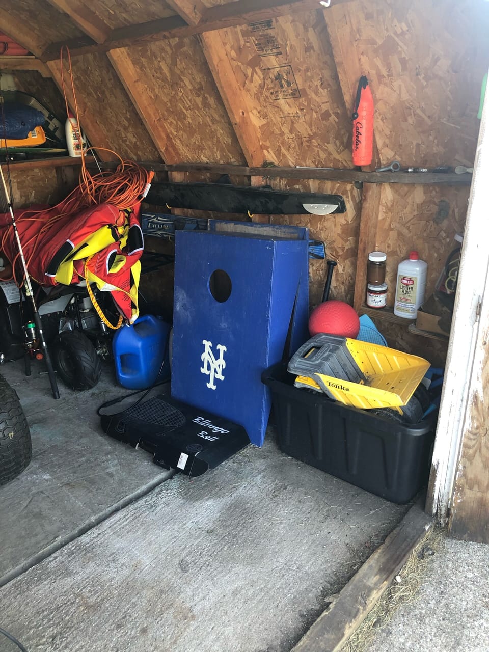 Shed items. Backyard games include spikeball and bags 