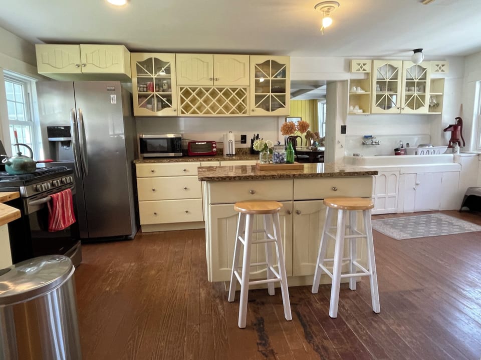 Kitchen: 6 burner gas stove, granite counter tops, old sink and pitcher pump
