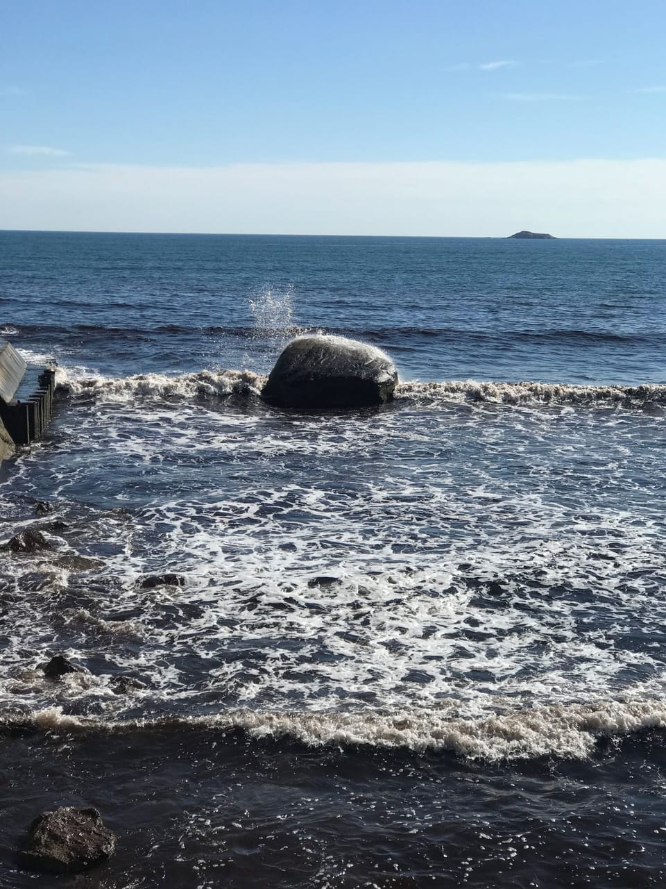 Stroll the beach and watch the waves hit the rocks