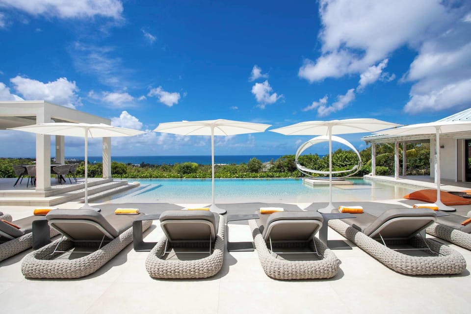 Private pool with sun-loungers and ocean view